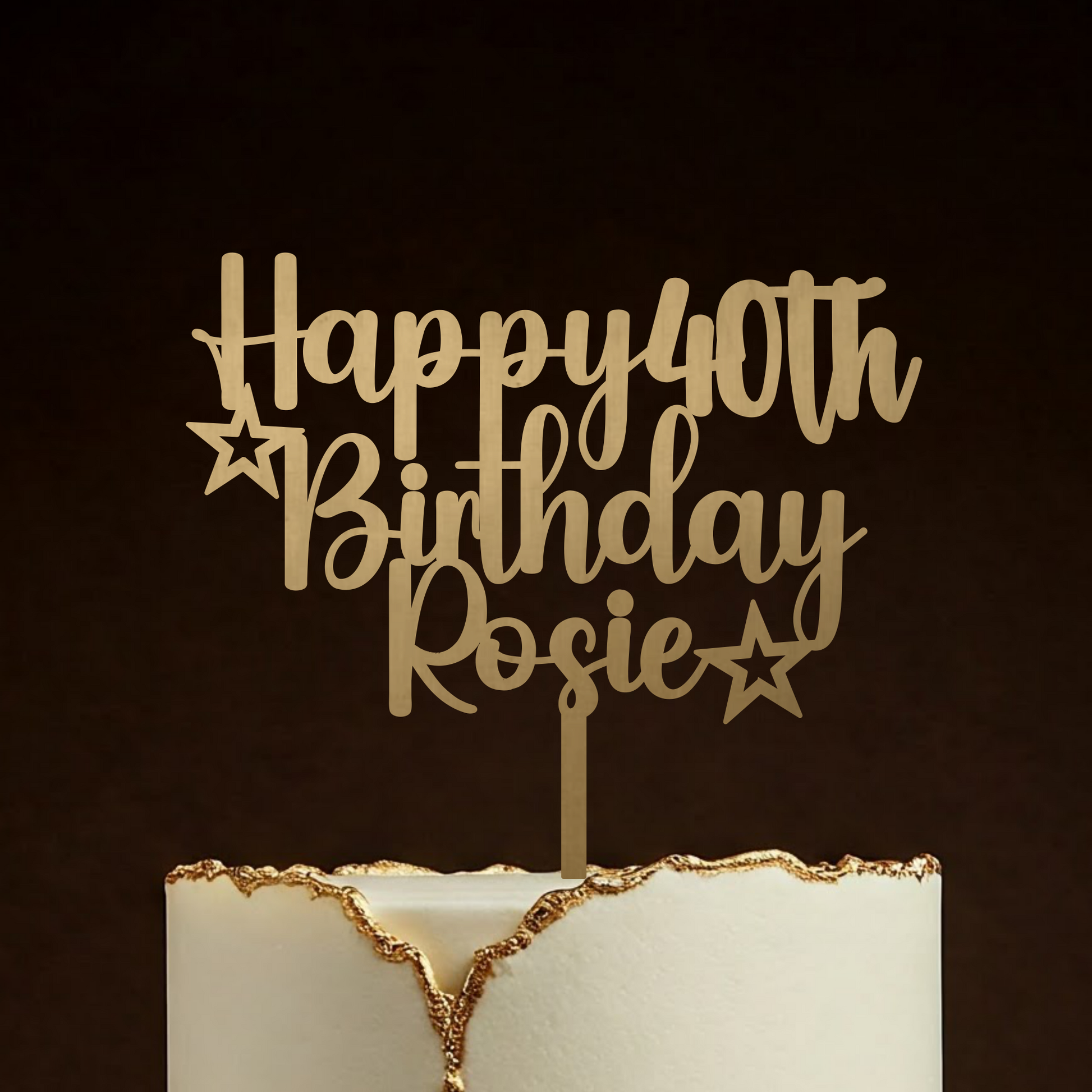 Gold 'Happy 40th Birthday Rosie' cake topper on a white cake with gold edge against a dark background